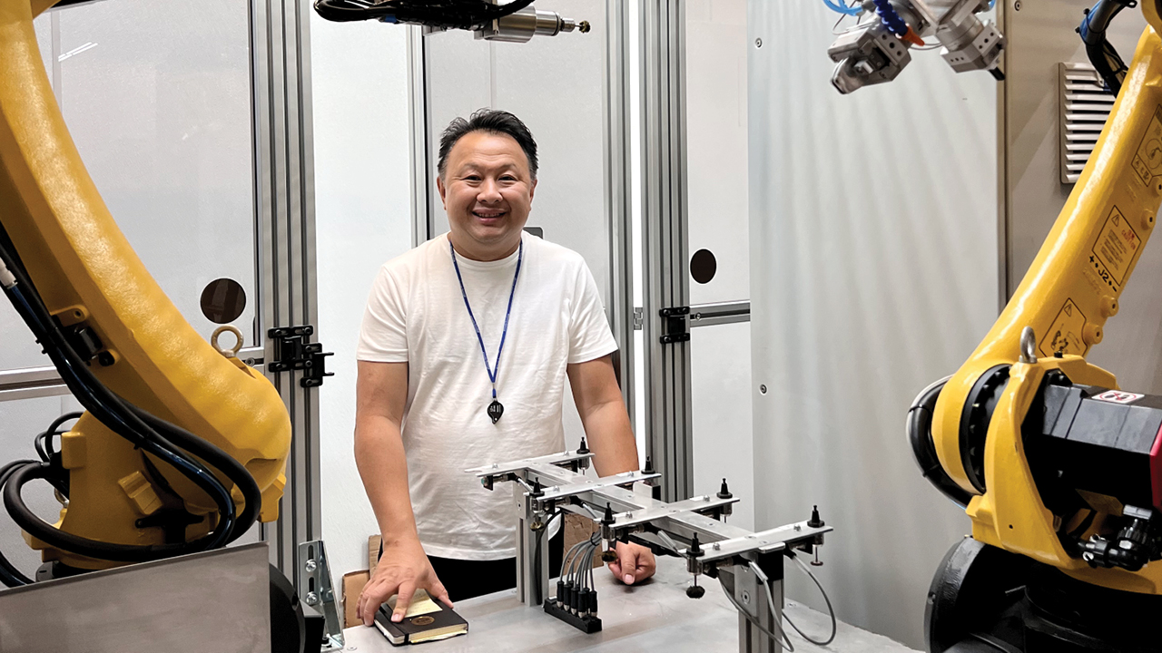 Image: Christian Tse stands beside his robotic polishing system. (Christian Tse)